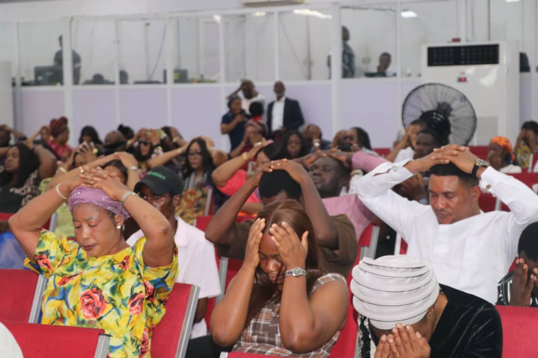 Trinity House congregation praying during service